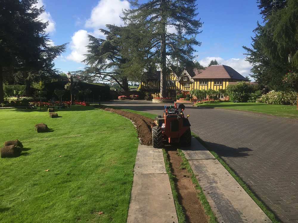 Lawn carefully lifted before being trenched and pipework installed